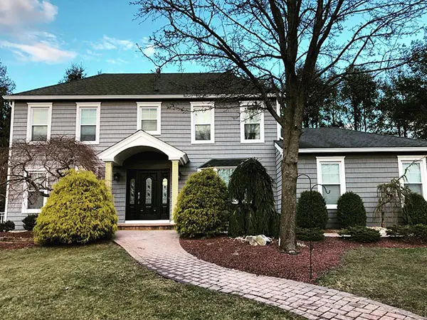 New gray vinyl shake siding on home